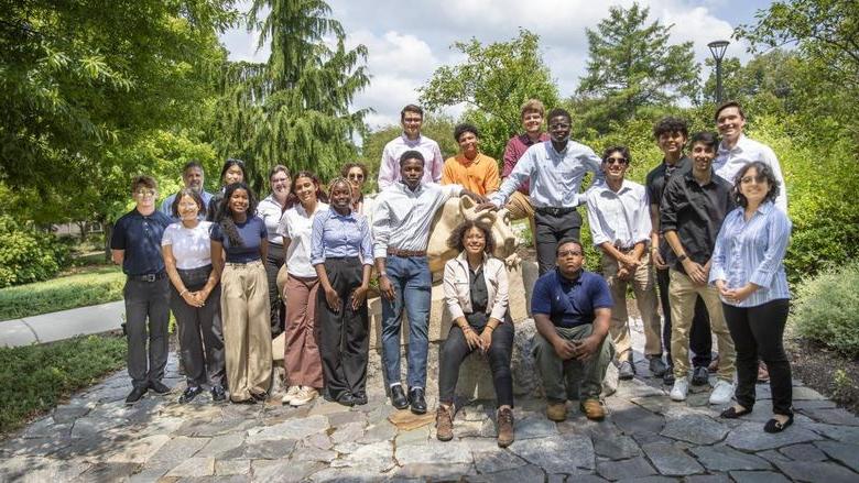 Students in the Engineering Ahead program pose for a photo around the Nittany Lion shrine